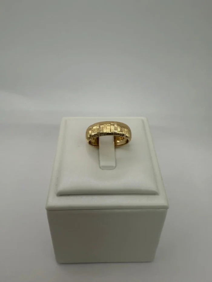 Anillo de oro 18KT Ley 750 con textura grabada, 9 gramos, sobre exhibidor blanco. Joyería de oro puro Venecia Gold.